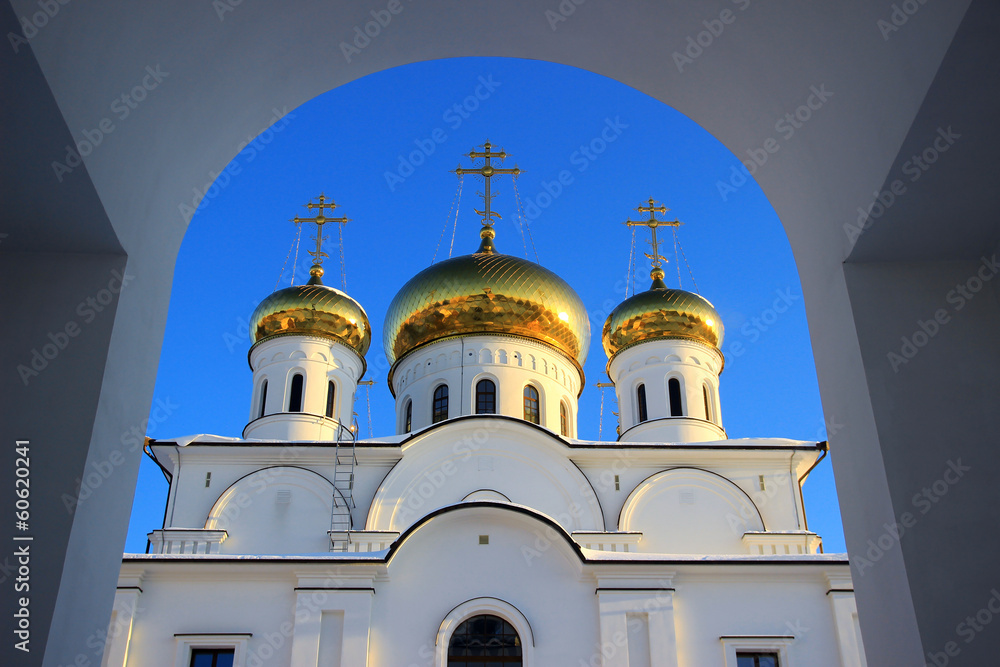 Russian orthodox church at winter blue sky. View through arch Russian orthodox church at winter blue sky. View through arch