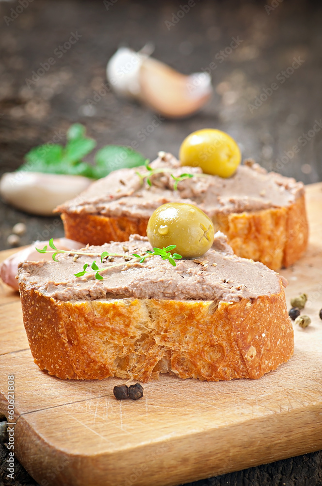 Homemade meat snack chicken liver pate with savory and olives