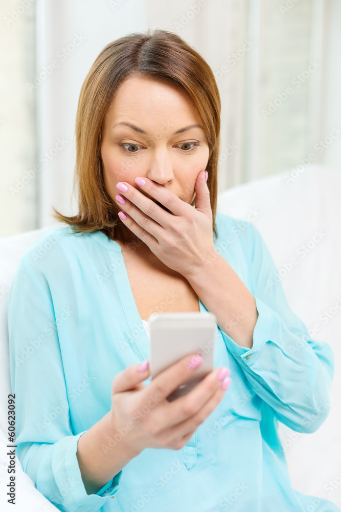surprised woman with smartphone at home surprised woman with smartphone at home