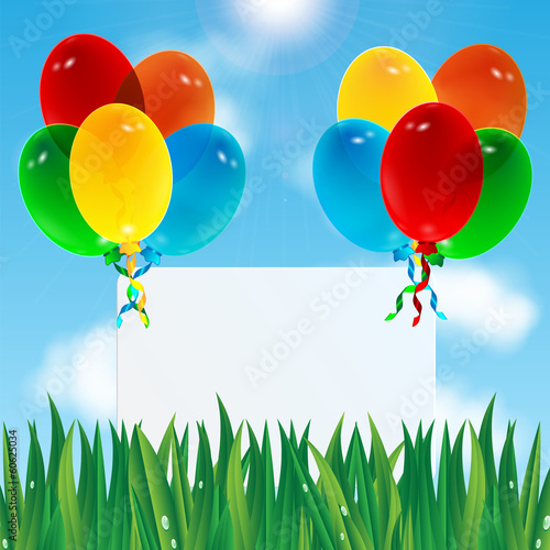 colorful balloons and paper against the sky and green grass.cele