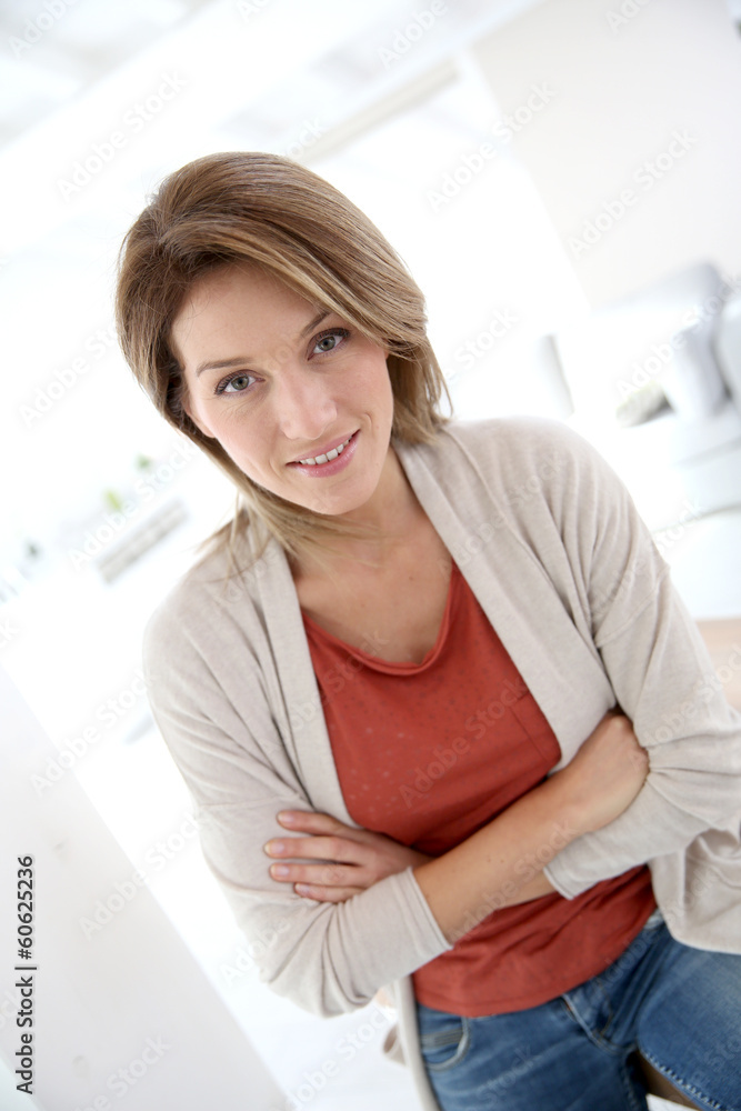 Middle-aged woman standing in modern home Middle-aged woman standing in modern home