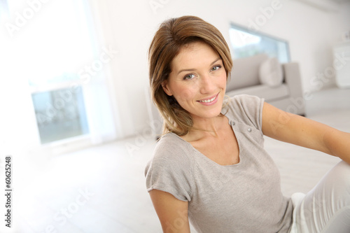Smiling attractive woman relaxing at home