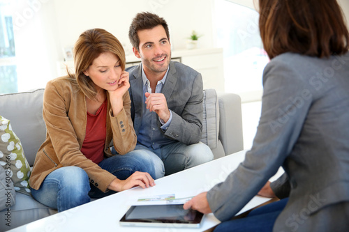 Couple meeting financial adviser for real estate project