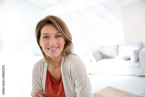 Middle-aged woman standing in modern home