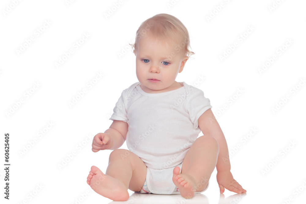 Adorable blonde baby sitting on the floor Adorable blonde baby sitting on the floor