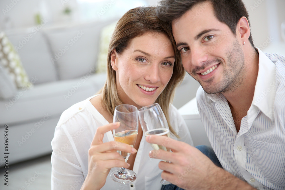 Couple at home celebrating new house purchase Couple at home celebrating new house purchase