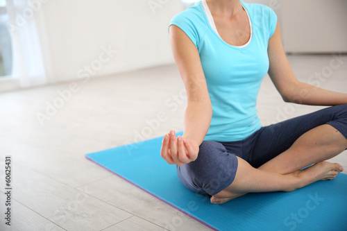 Focus on woman doing yoga exercises
