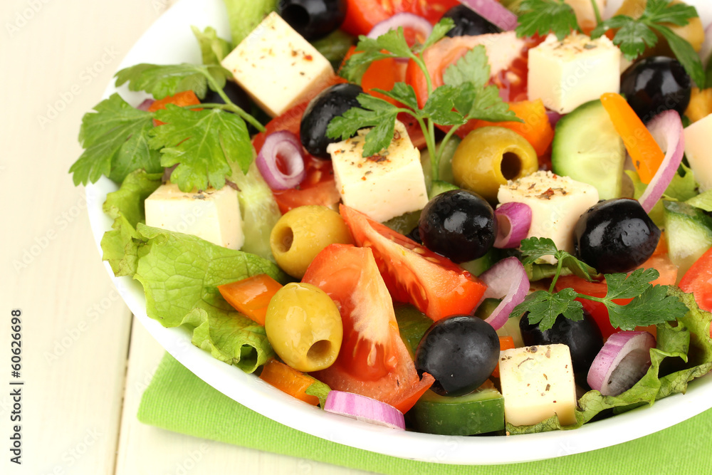 Fresh salad in plate on wooden table Fresh salad in plate on wooden table