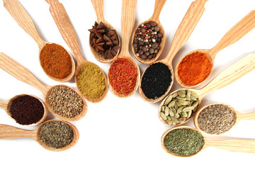 Fototapete Gewürze Assortment of spices in wooden spoons, isolated on white  © Africa Studio