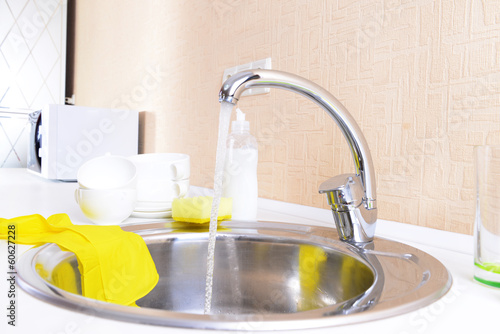 Dishes drying near metal sink