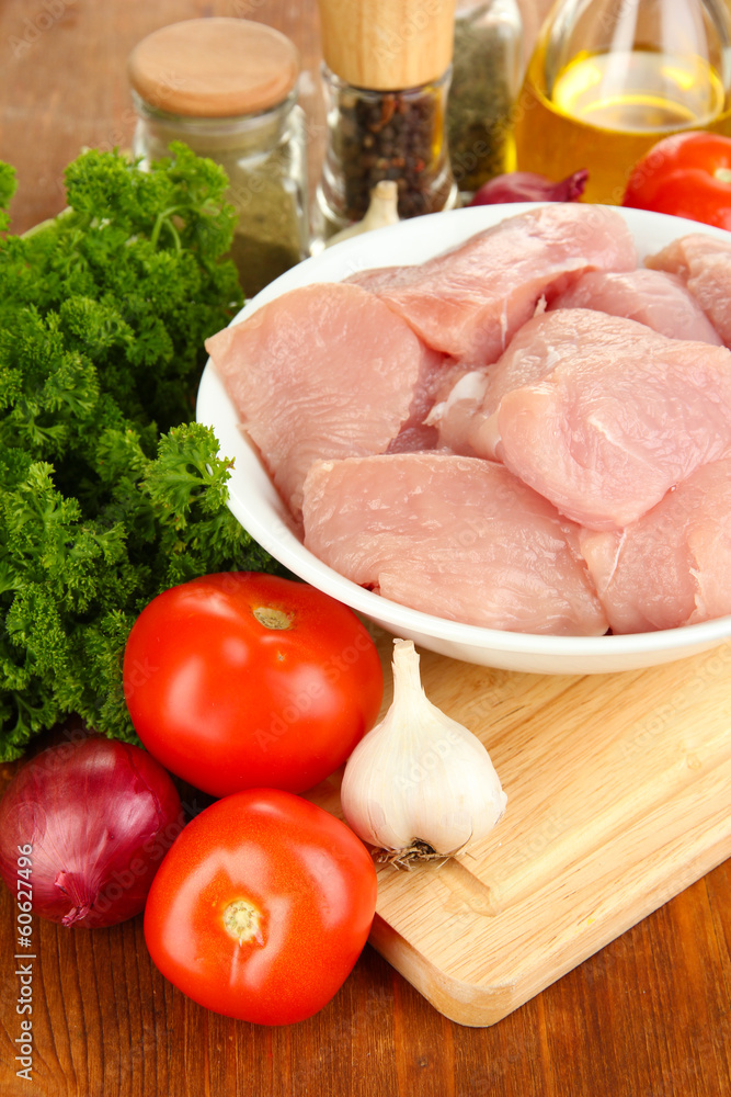 Raw turkey meat on wooden table close up Raw turkey meat on wooden table close up