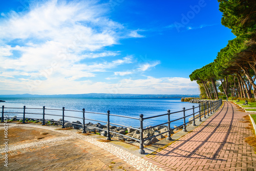 Fototapeta Naklejka Na Ścianę i Meble -  Promenade and pine trees in Bolsena lake, Italy.