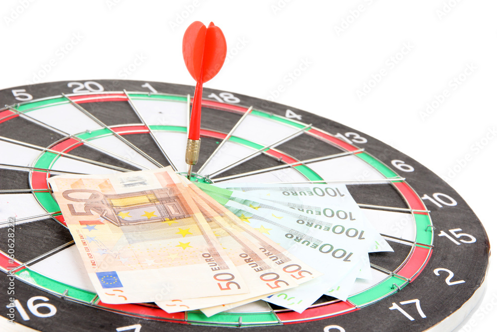 Dart on dartboard and money close up. Concept of success. Dart on dartboard and money close up. Concept of success.
