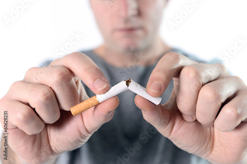 man breaking cigarette representing quit smoking