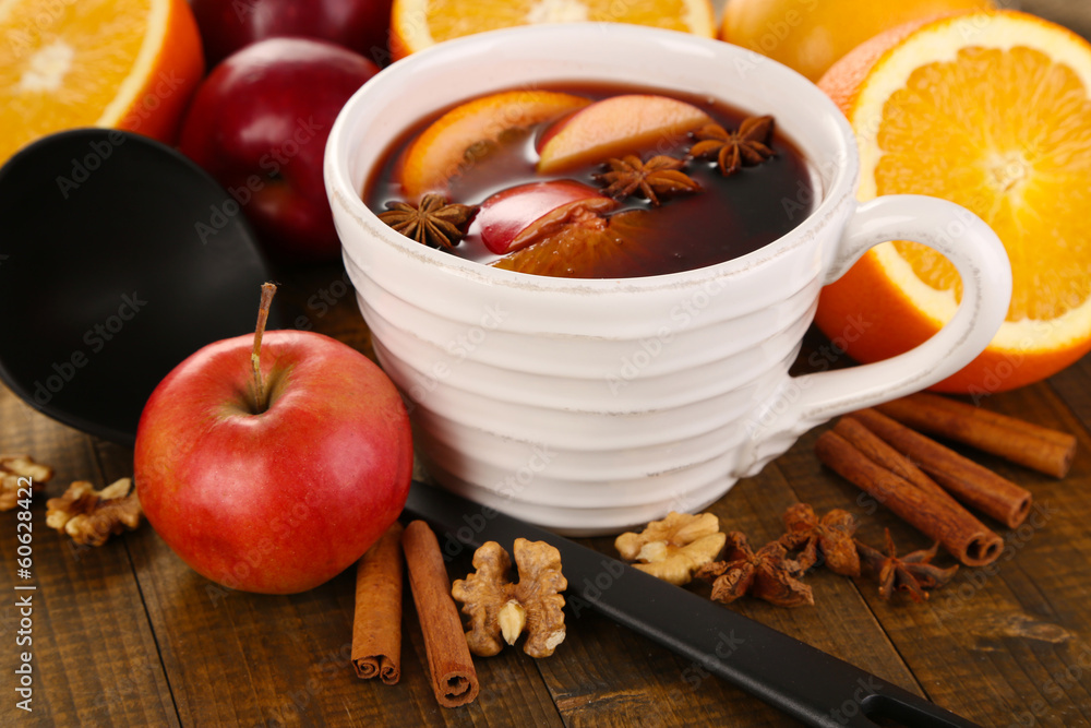 Fragrant mulled wine in bowl on wooden table close-up Fragrant mulled wine in bowl on wooden table close-up