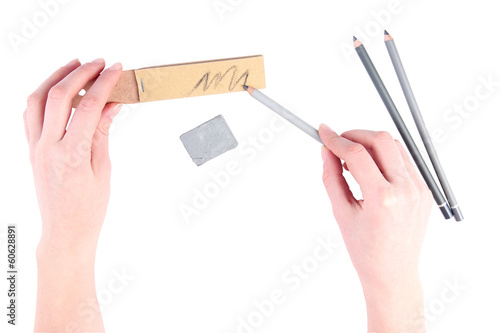 Hands with pencils and erase isolated on white