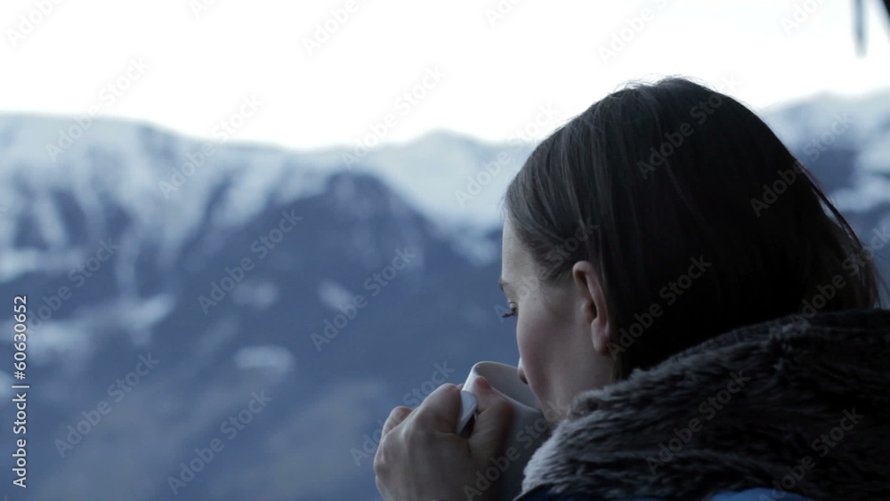 Beautiful girl drinking hot tea in the mountains, close up Beautiful girl drinking hot tea in the mountains, close up