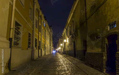 Night photo of a cobbled street in the old part of Poznan, Polan