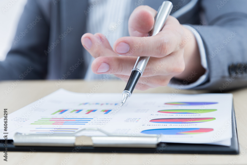 Businessman's hand showing financial report Businessman's hand showing financial report
