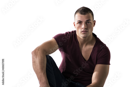 Handsome young man with t-shirt and jeans, sitting