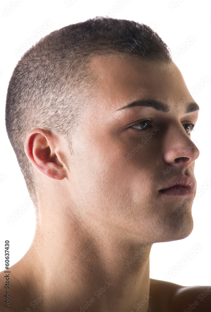 Close-up headshot of attractive young man, looking to a side Close-up headshot of attractive young man, looking to a side