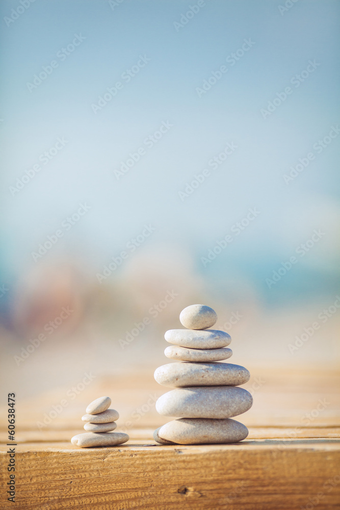 zen stones jy wooden banch on the beach near sea. Outdoor - obrazy, fototapety, plakaty 