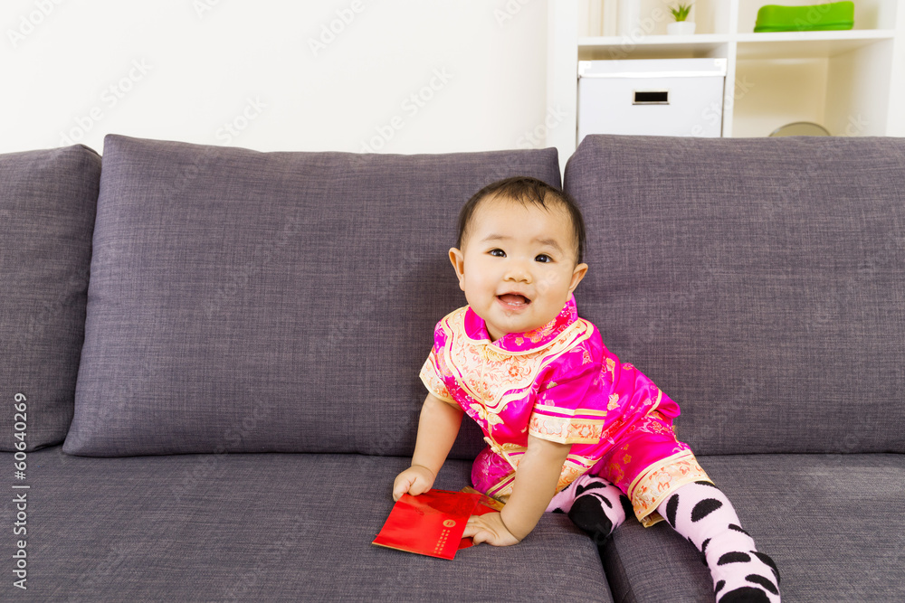 Asian baby holding red pocket with traditional chinese clothing Asian baby holding red pocket with traditional chinese clothing