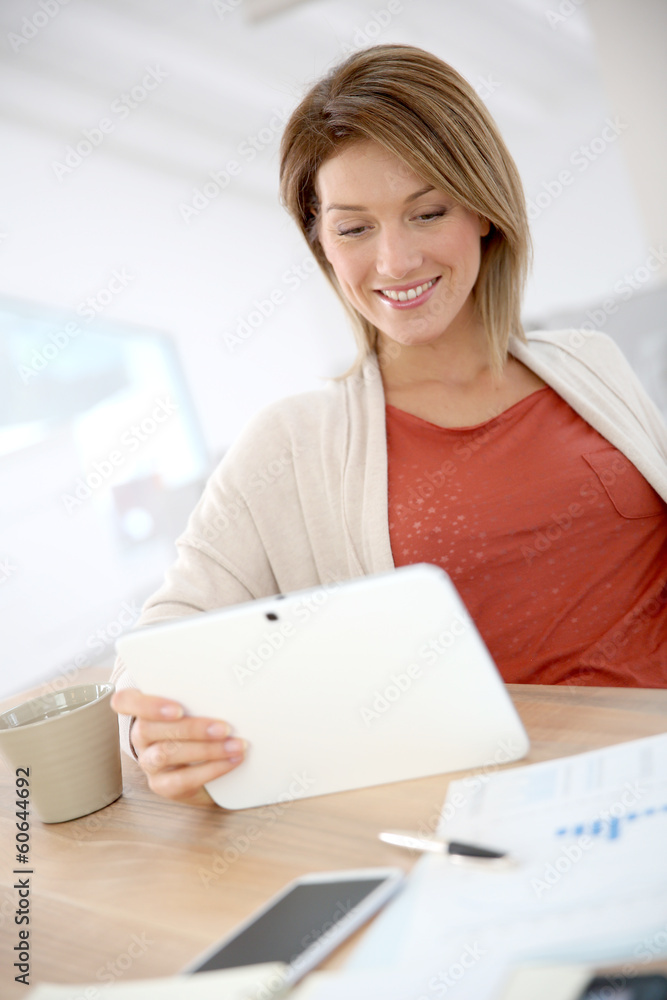 Woman working from home on digital tablet Woman working from home on digital tablet