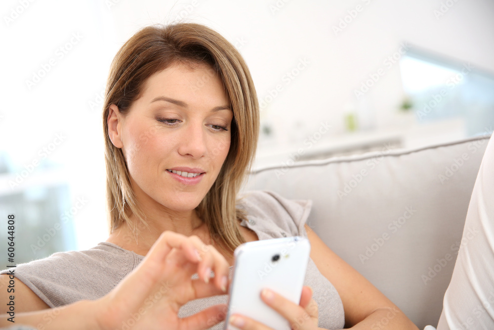 Middle-aged woman sending message with smartphone Middle-aged woman sending message with smartphone