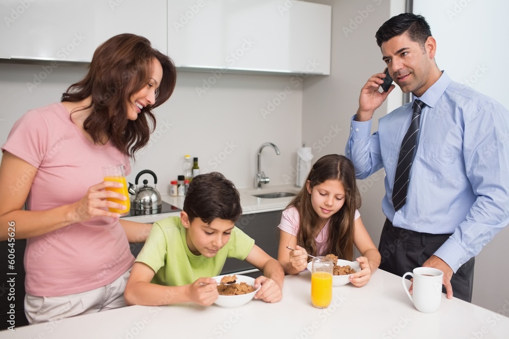 Kids with parents having breakfast in kitchen Kids with parents having breakfast in kitchen