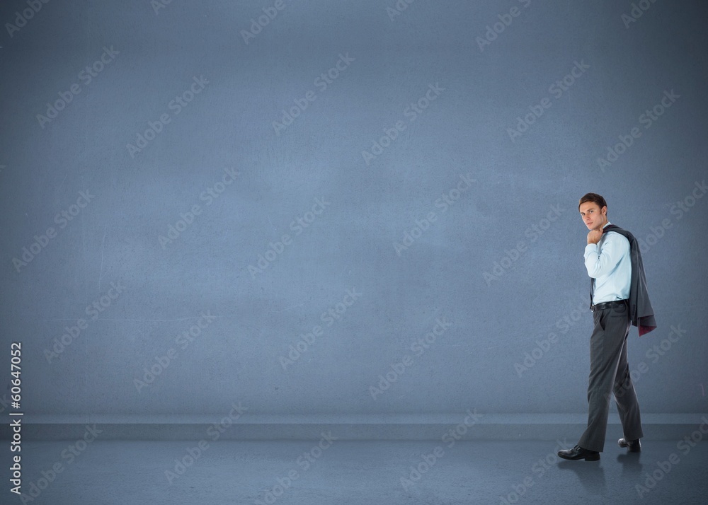 Composite image of serious businessman holding his jacket Composite image of serious businessman holding his jacket