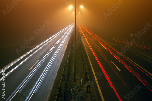 Night traffic on a highway in the fogy night