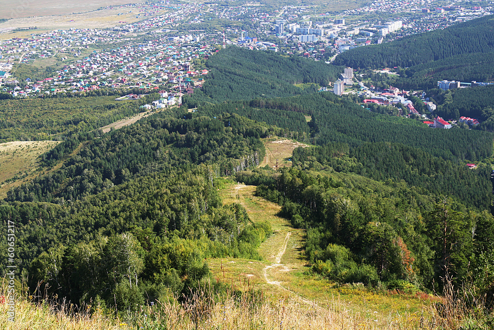 Town from a bird's flight and ski descent from the mountain