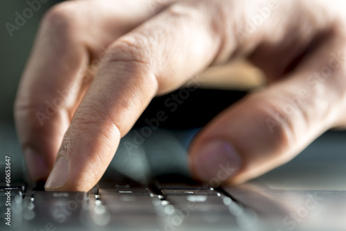 Man typing on a laptop computer