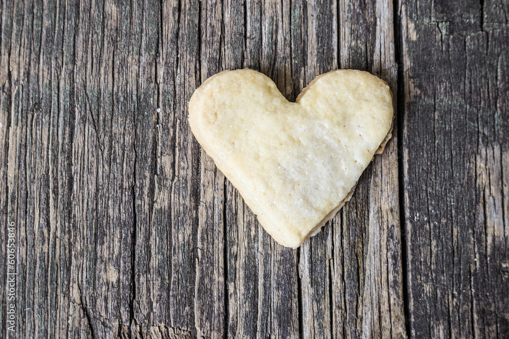 Fototapeta premium Heart of the cookies and the wooden background.