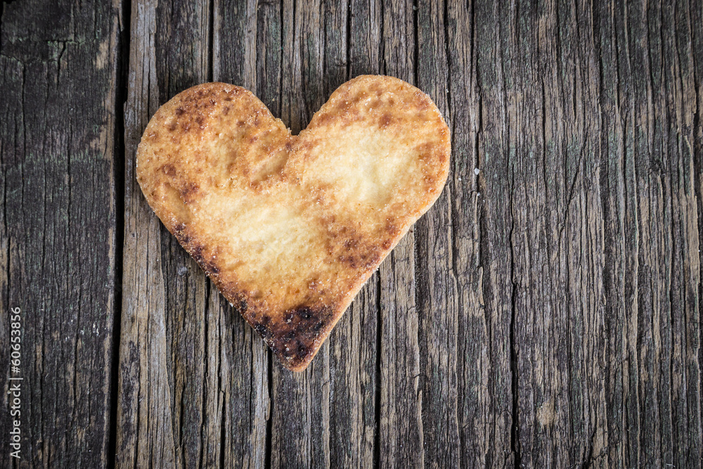 Fototapeta premium Heart of the cookies and the wooden background.