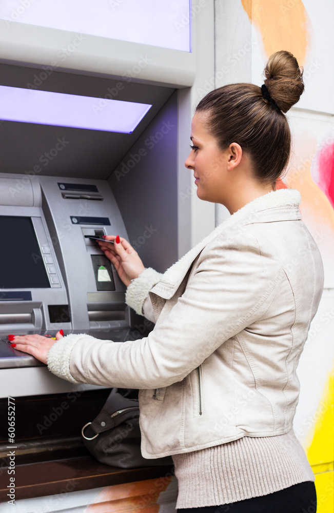 Young woman withdrawing money Young woman withdrawing money