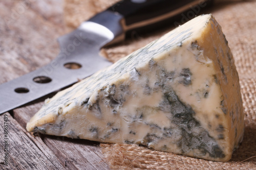 Принти на полотні Blue cheese on sackcloth close up on an old wooden table