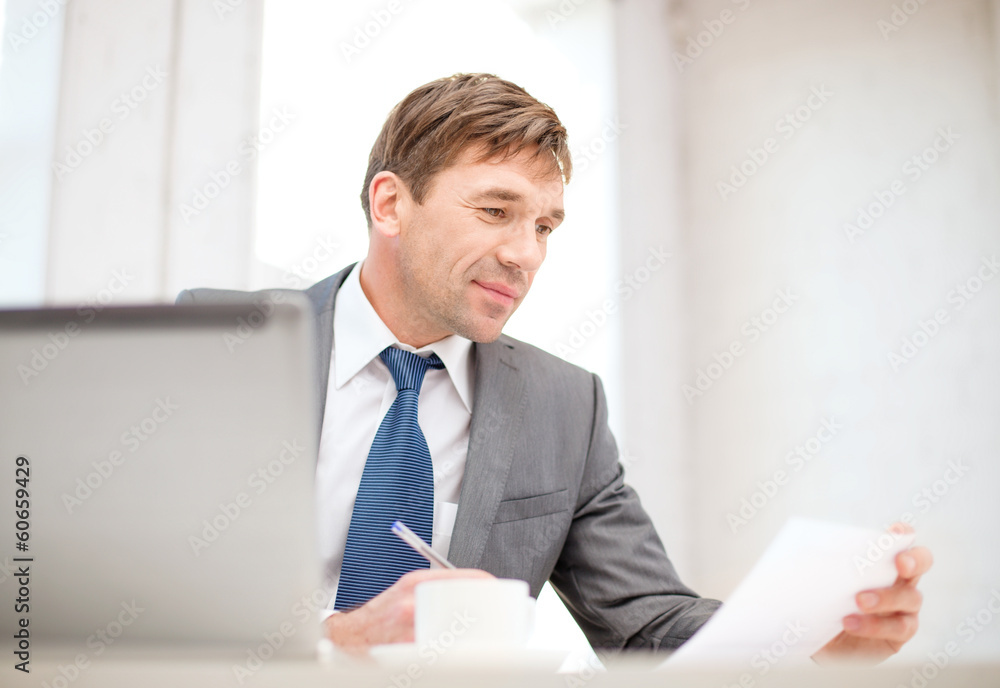 businessman with laptop computer and documents businessman with laptop computer and documents