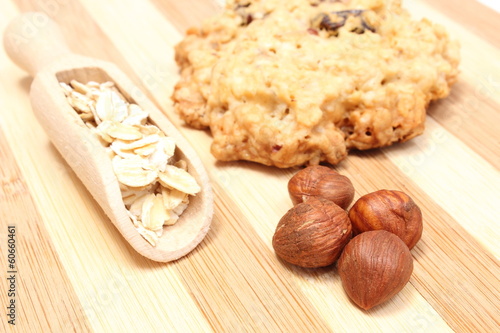 Oatmeal cookies with hazelnut on wooden background