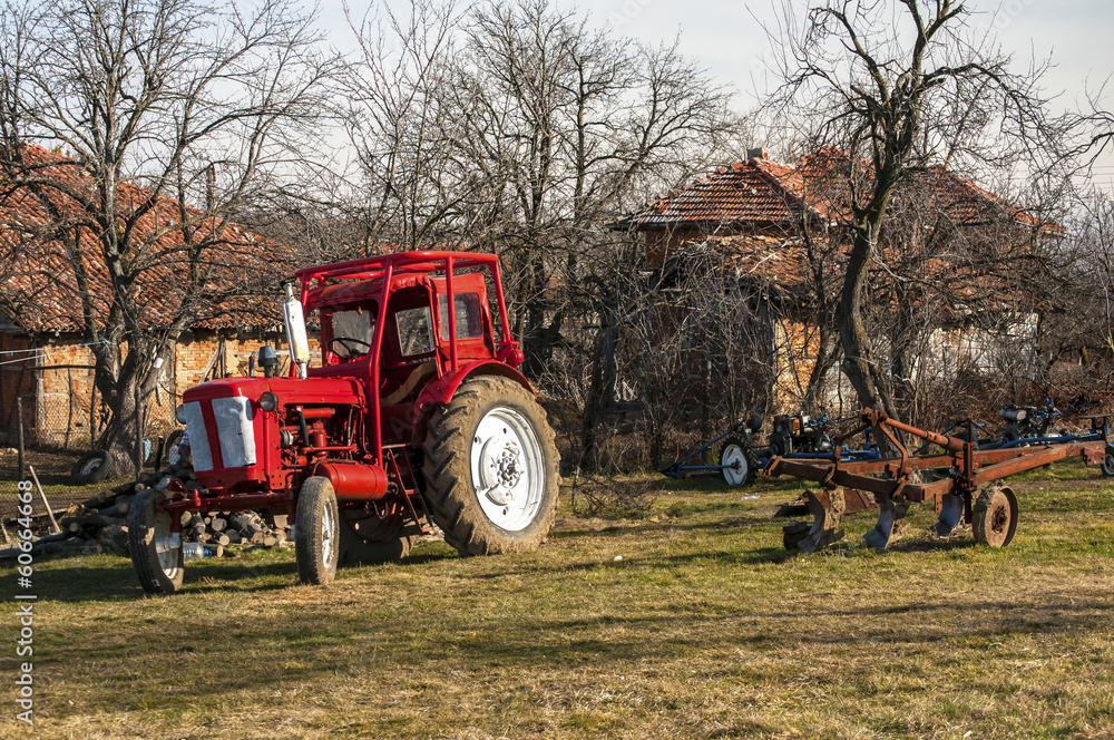 Obraz premium View from a mountain farm with tractor on meadow