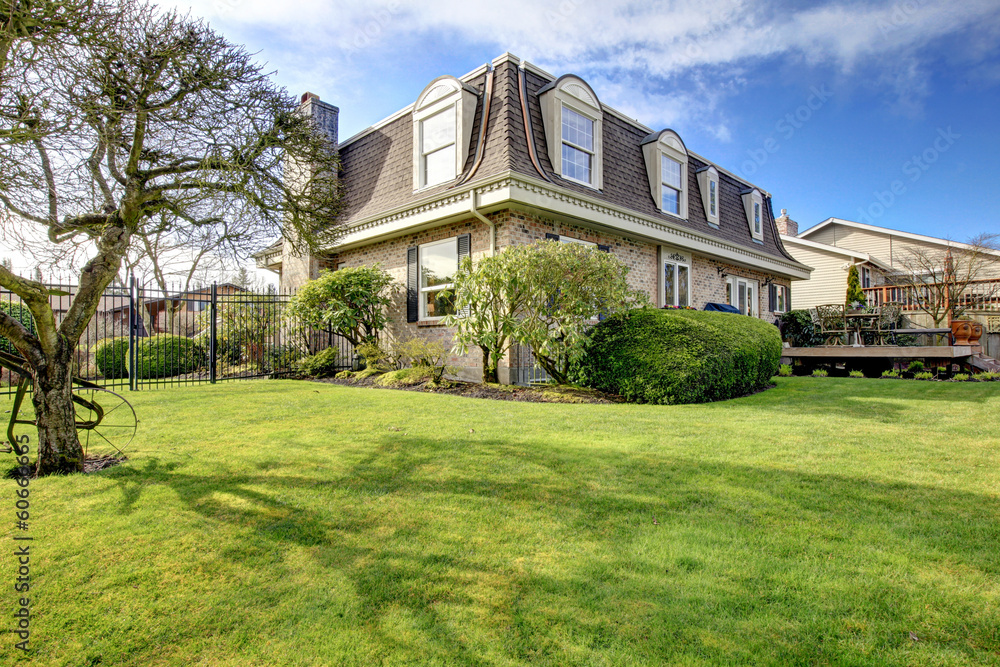 Wonderful classic stone facing house with backyard flowerbed, tr