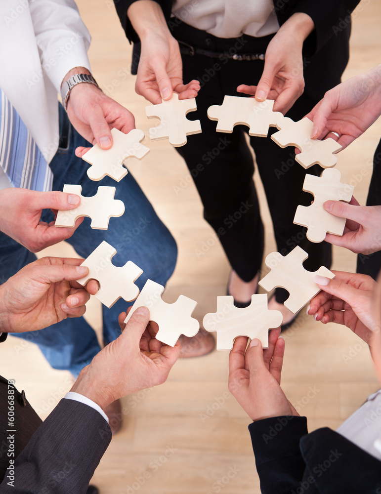Business People Holding Jigsaw Puzzle Business People Holding Jigsaw Puzzle