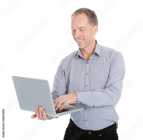 Happy Businessman Holding Laptop