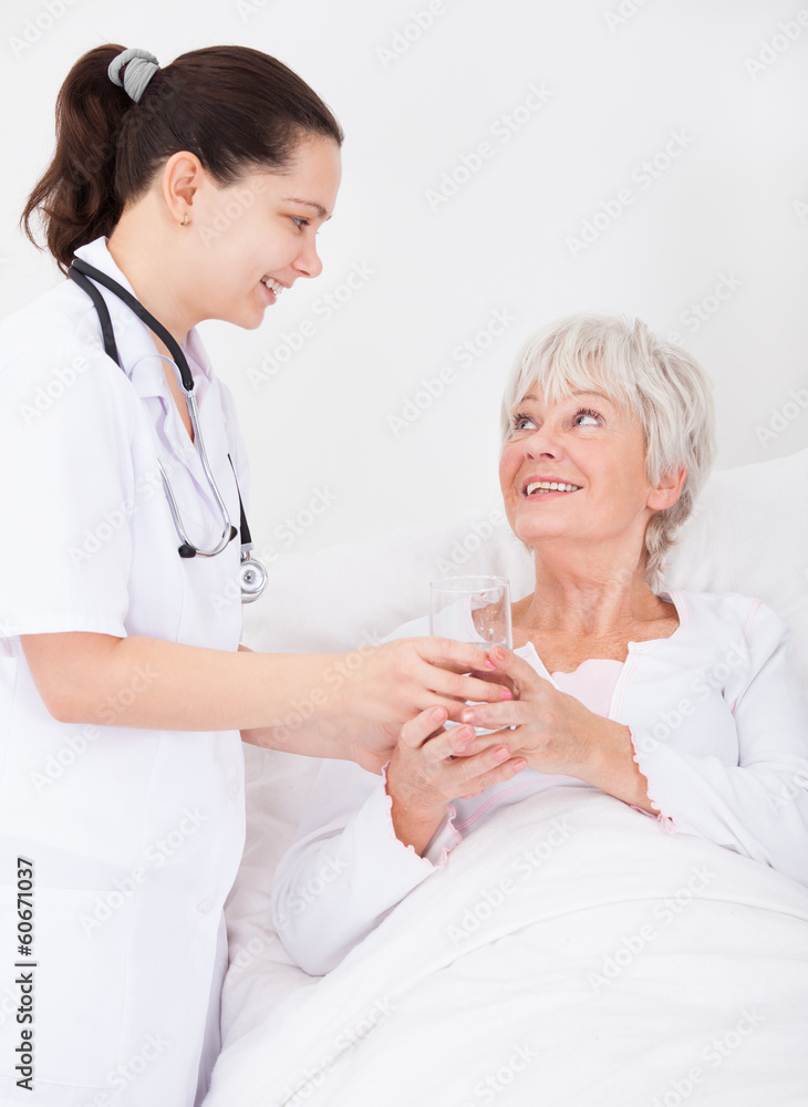 Doctor Giving Water To Senior Patient Doctor Giving Water To Senior Patient