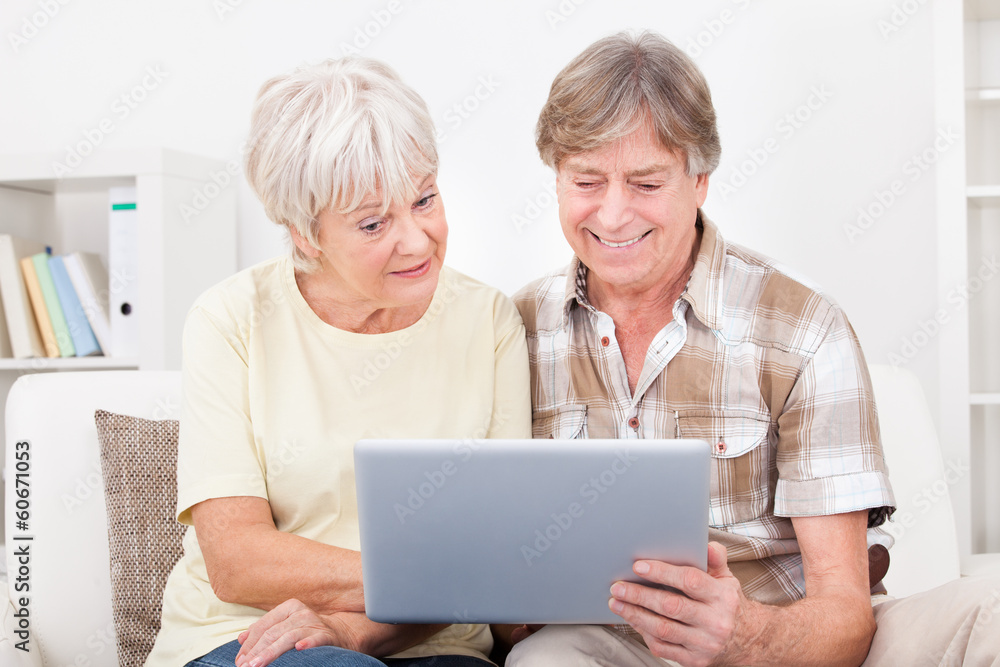 Senior Couple Looking At Laptop