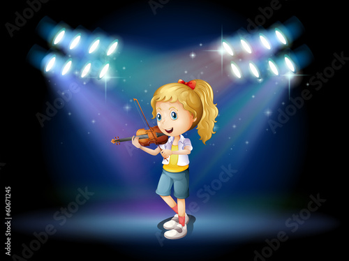 A young girl playing with her violin at the stage