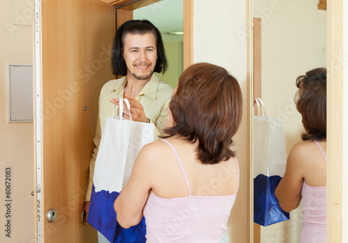 man came to the woman with a gift at home