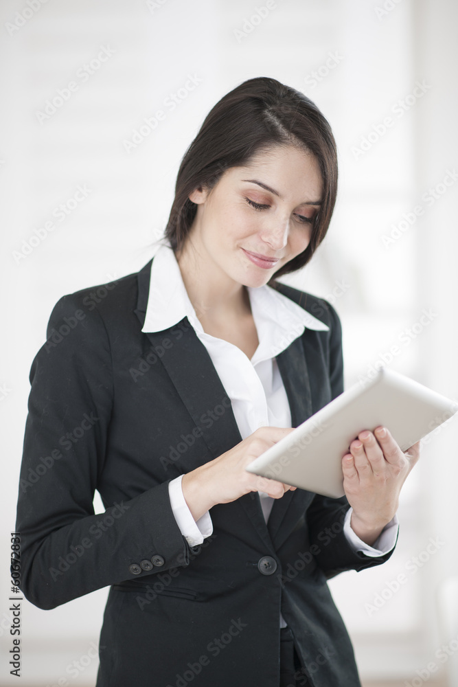 smiling businesswoman using tablet smiling businesswoman using tablet