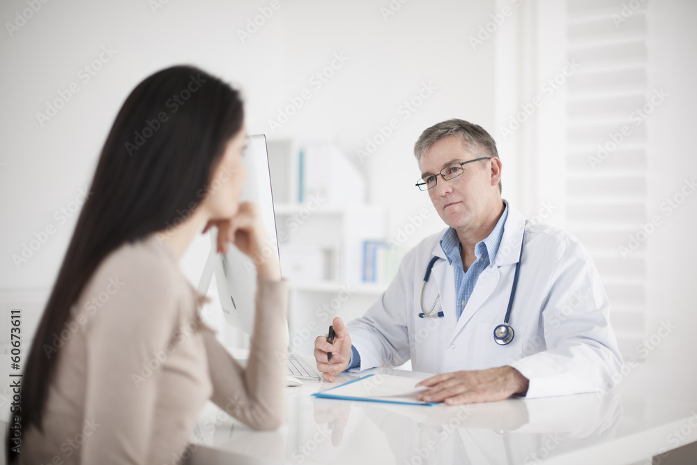 senior doctor consulting female patient senior doctor consulting female patient
